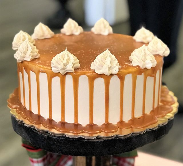 Layered caramel cake with glossy caramel icing dripping down the sides