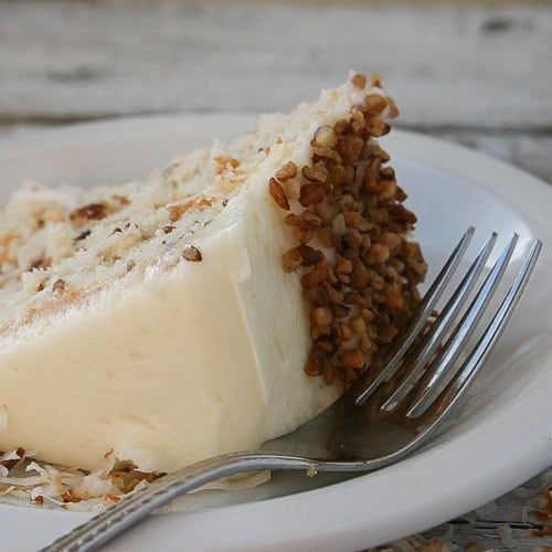 Italian cream cake with coconut and pecans between layers and cream cheese frosting