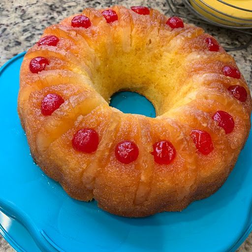 Pineapple upside-down cake with caramelized pineapple rings and cherries on top